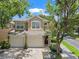 Charming two-story townhome featuring a two-car garage, well-maintained landscaping, and a welcoming entryway at 6453 Alcalde Ct # 110, Orlando, FL 32835