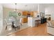 Bright kitchen with light wood cabinets, stainless steel microwave, and adjacent dining area at 6453 Alcalde Ct # 110, Orlando, FL 32835