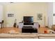 Spacious living room features high ceilings, wood floors, and neutral-colored walls at 6453 Alcalde Ct # 110, Orlando, FL 32835