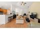 Open-concept layout with kitchen bar, comfortable seating, and hardwood floors at 6453 Alcalde Ct # 110, Orlando, FL 32835