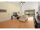 Bright open living area with hardwood floors, comfortable sofa, and screened-in patio at 6453 Alcalde Ct # 110, Orlando, FL 32835