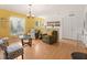 Cozy living room with wood floors, natural light, and comfortable seating arrangement at 6453 Alcalde Ct # 110, Orlando, FL 32835