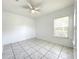 Well-lit bedroom features tiled flooring, a ceiling fan and lots of natural light at 6524 Swissco Dr # 1012, Orlando, FL 32822