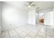 This bedroom features tiled floors, a ceiling fan, and an ensuite bathroom at 6524 Swissco Dr # 1012, Orlando, FL 32822
