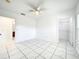Bedroom featuring bright natural light, tiled floors, a ceiling fan, and closet space at 6524 Swissco Dr # 1012, Orlando, FL 32822