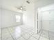 Bright bedroom features a ceiling fan, tiled floors and a walk in closet with shelving at 6524 Swissco Dr # 1012, Orlando, FL 32822