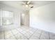 Bright bedroom featuring tiled floors, a ceiling fan, and bright natural light at 6524 Swissco Dr # 1012, Orlando, FL 32822