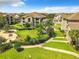An exterior community green area featuring landscaping, walkways and lush lawn space at 6524 Swissco Dr # 1012, Orlando, FL 32822