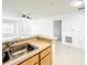 Open kitchen with double sink, breakfast bar and a view into the living room at 6524 Swissco Dr # 1012, Orlando, FL 32822