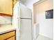 A refrigerator and a dryer next to wood kitchen cabinets at 6524 Swissco Dr # 1012, Orlando, FL 32822