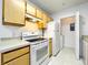 Kitchen offers updated white appliances, modern countertop, and ample cabinet space at 6524 Swissco Dr # 1012, Orlando, FL 32822