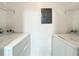 Functional laundry room with white washer, dryer, wire shelving, and neutral walls at 6524 Swissco Dr # 1012, Orlando, FL 32822
