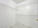 Walk-in closet with tiled floor and built-in wire shelving to maximize storage space at 6524 Swissco Dr # 1012, Orlando, FL 32822