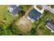 An aerial view of a home and vacant lot, showcasing the property's location and proximity to neighboring houses at 9122 Trevarthon Rd, Orlando, FL 32817