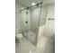 Modern bathroom featuring a glass shower with marble-look tile and a sleek design at 9122 Trevarthon Rd, Orlando, FL 32817