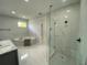Spa-like bathroom with soaking tub, glass shower, double vanity, and modern finishes at 9122 Trevarthon Rd, Orlando, FL 32817