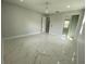 Well-lit bedroom with closet, sleek marble floors, and ceiling fan at 9122 Trevarthon Rd, Orlando, FL 32817
