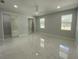 Light-filled bedroom with marble floors, ceiling fan, and ample closet space at 9122 Trevarthon Rd, Orlando, FL 32817