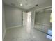 Bright bedroom with a ceiling fan, a closet with mirrored doors and marble floors at 9122 Trevarthon Rd, Orlando, FL 32817
