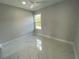 Bright bedroom featuring a ceiling fan, large window, and neutral wall color at 9122 Trevarthon Rd, Orlando, FL 32817