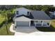 Beautiful two-story home featuring a spacious driveway, covered porch, and lush landscaping at 9122 Trevarthon Rd, Orlando, FL 32817