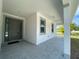 Inviting front porch with modern gray door, tiled floor, recessed lights, and ceiling fan at 9122 Trevarthon Rd, Orlando, FL 32817