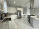 Bright kitchen with white cabinets, stainless appliances, mosaic backsplash, and a sleek island at 9122 Trevarthon Rd, Orlando, FL 32817