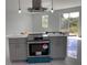 New kitchen featuring an island with granite countertop and stainless steel appliances still in wrapper at 9122 Trevarthon Rd, Orlando, FL 32817