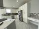 New kitchen featuring an island, stainless steel appliances, granite countertops, and white cabinets at 9122 Trevarthon Rd, Orlando, FL 32817