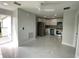 Open-concept kitchen with modern appliances and marble floors connected to a spacious room at 9122 Trevarthon Rd, Orlando, FL 32817