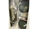 Modern laundry room featuring a stacked washer and dryer and an HVAC unit at 9122 Trevarthon Rd, Orlando, FL 32817
