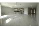 Spacious open-concept living room with marble floors and recessed lighting, leading to a modern kitchen at 9122 Trevarthon Rd, Orlando, FL 32817