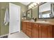 This bathroom features a double vanity with storage cabinets and drawers at 9275 Lake Sharp Ct, Orlando, FL 32817