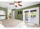 This spacious bedroom features french doors to the back patio at 9275 Lake Sharp Ct, Orlando, FL 32817