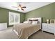This bedroom features a ceiling fan and a large window for ample natural light at 9275 Lake Sharp Ct, Orlando, FL 32817