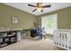 This bedroom features a white crib and a large window at 9275 Lake Sharp Ct, Orlando, FL 32817