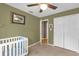 A bedroom with neutral carpet, ceiling fan and a large closet at 9275 Lake Sharp Ct, Orlando, FL 32817