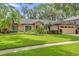 Beautiful single-story home featuring well-maintained lawn and mature landscaping at 9275 Lake Sharp Ct, Orlando, FL 32817