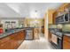 This spacious kitchen has granite countertops, stainless steel appliances and tile flooring at 9275 Lake Sharp Ct, Orlando, FL 32817