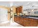 Well-maintained kitchen with granite countertops and wooden cabinets, with dining area access at 9275 Lake Sharp Ct, Orlando, FL 32817