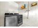 Modern laundry room with gray front-load washer and dryer at 9275 Lake Sharp Ct, Orlando, FL 32817