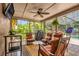 Screened patio with comfortable seating and an outdoor entertainment area at 9275 Lake Sharp Ct, Orlando, FL 32817