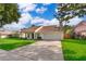 Charming home featuring a well-manicured lawn, driveway, and attached two-car garage at 1017 Gould Pl, Oviedo, FL 32765