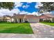 Charming single-story home with a well-manicured lawn and a two-car garage at 1017 Gould Pl, Oviedo, FL 32765