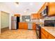 Modern kitchen featuring stainless steel appliances, granite countertops, and ample cabinet space at 1017 Gould Pl, Oviedo, FL 32765
