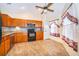 Traditional kitchen with tile floors, ceiling fan, stainless steel dishwasher, and solid surface countertops at 1017 Gould Pl, Oviedo, FL 32765