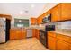 Traditional kitchen with stainless steel appliances, solid surface countertops, and decorative tiled backsplash at 1017 Gould Pl, Oviedo, FL 32765