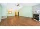 Well-lit living area showcasing a fireplace, hardwood floors, and a kitchen pass-through at 1017 Gould Pl, Oviedo, FL 32765
