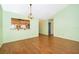 Bright and inviting living area with a passthrough to the kitchen, and hardwood flooring at 1017 Gould Pl, Oviedo, FL 32765