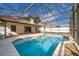 Inviting screened-in pool with clear blue water and stone accents at 1017 Gould Pl, Oviedo, FL 32765